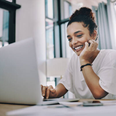 Shot of a young businesswoman using a laptop while working in her home office