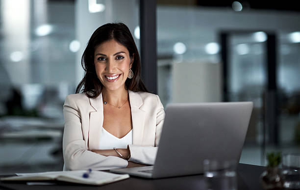 Portrait of a happy businesswoman working at her office desk